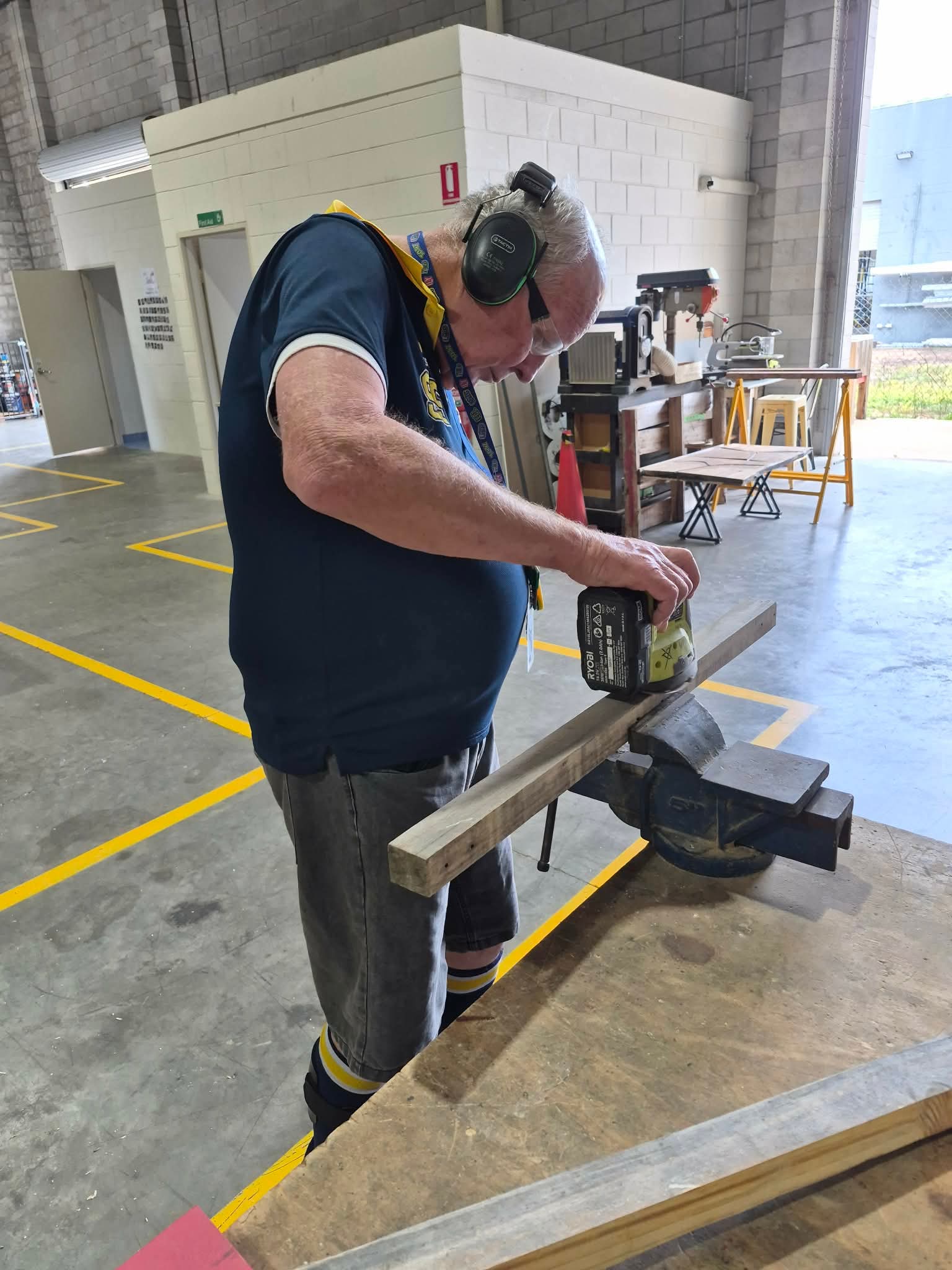 Participant safely using a tool at a workbench